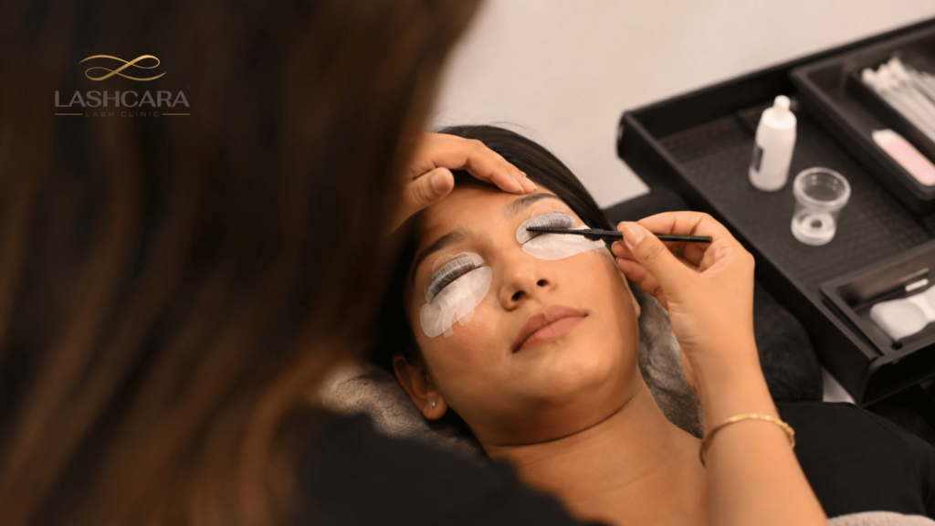 Lash artist performing a professional lash lift on an Indian client using silicone shields at Lashcara Lash Clinic in Pune.